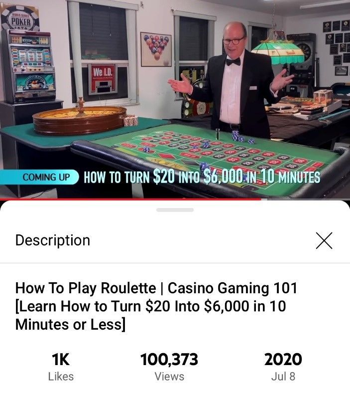 A man in a tuxedo stands in front of a roulette table