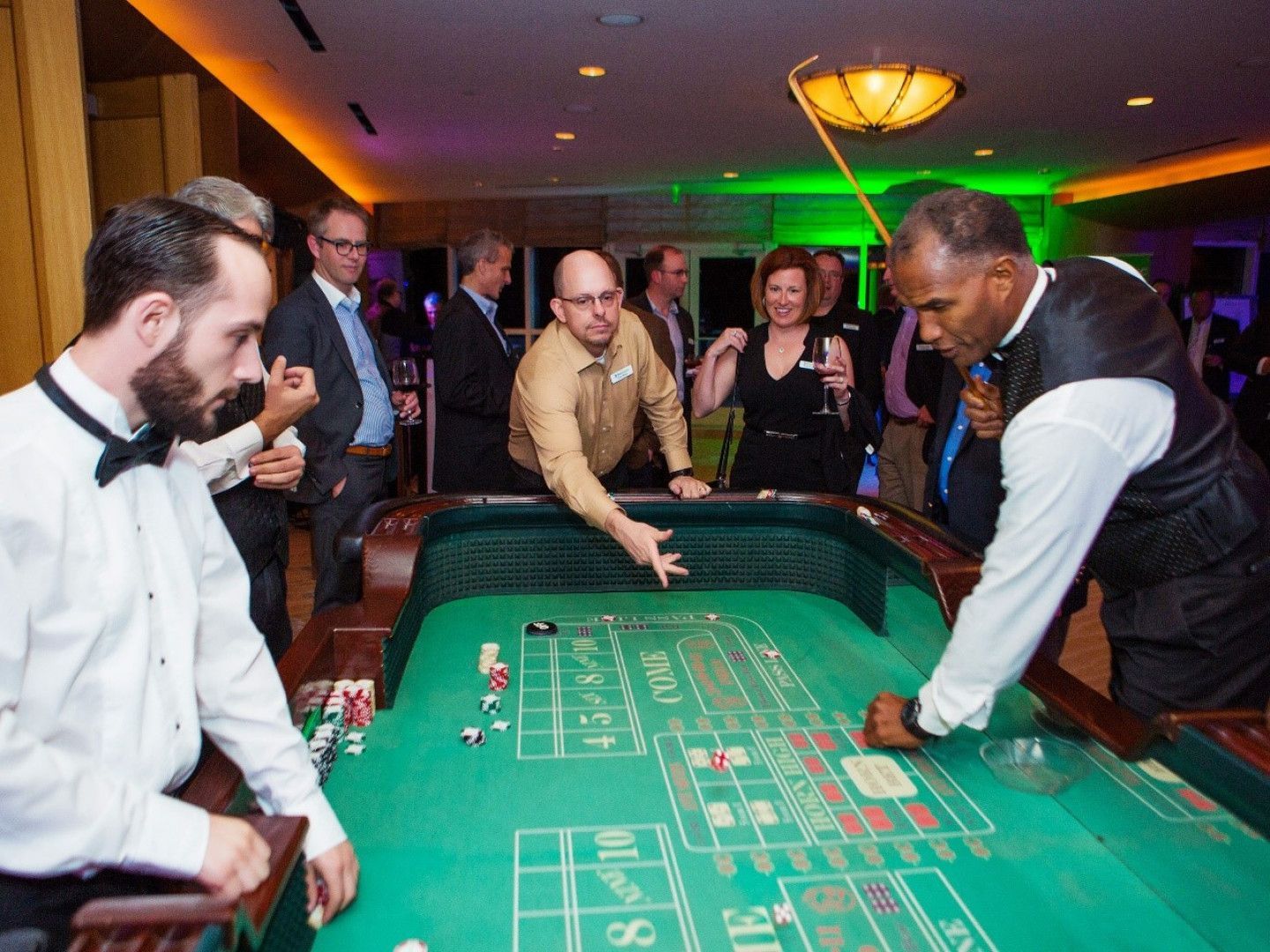 A group of people are playing roulette in a casino