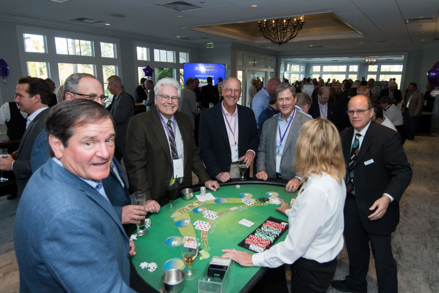 A group of people are playing a game of blackjack at a table.