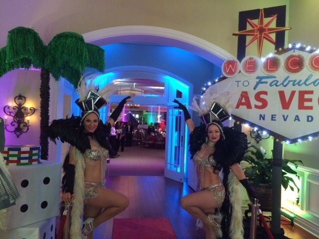 Two women standing in front of a sign that says 
