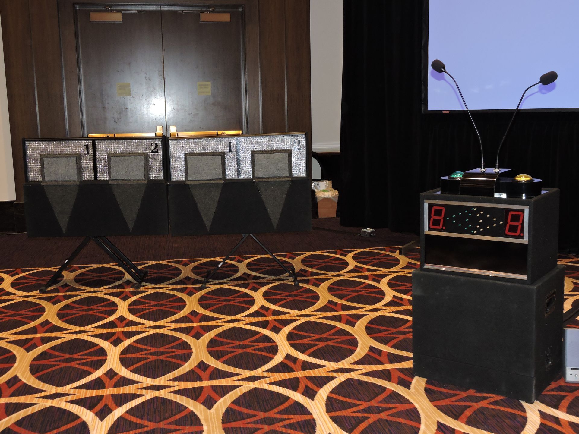 A podium with two microphones and a digital display that says 8 on it