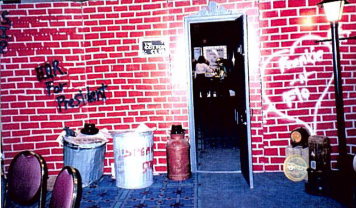 trashcans in front of a brick wall with an open door