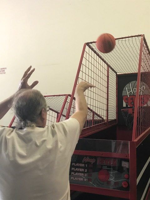 A man is playing a game of hoop basketball