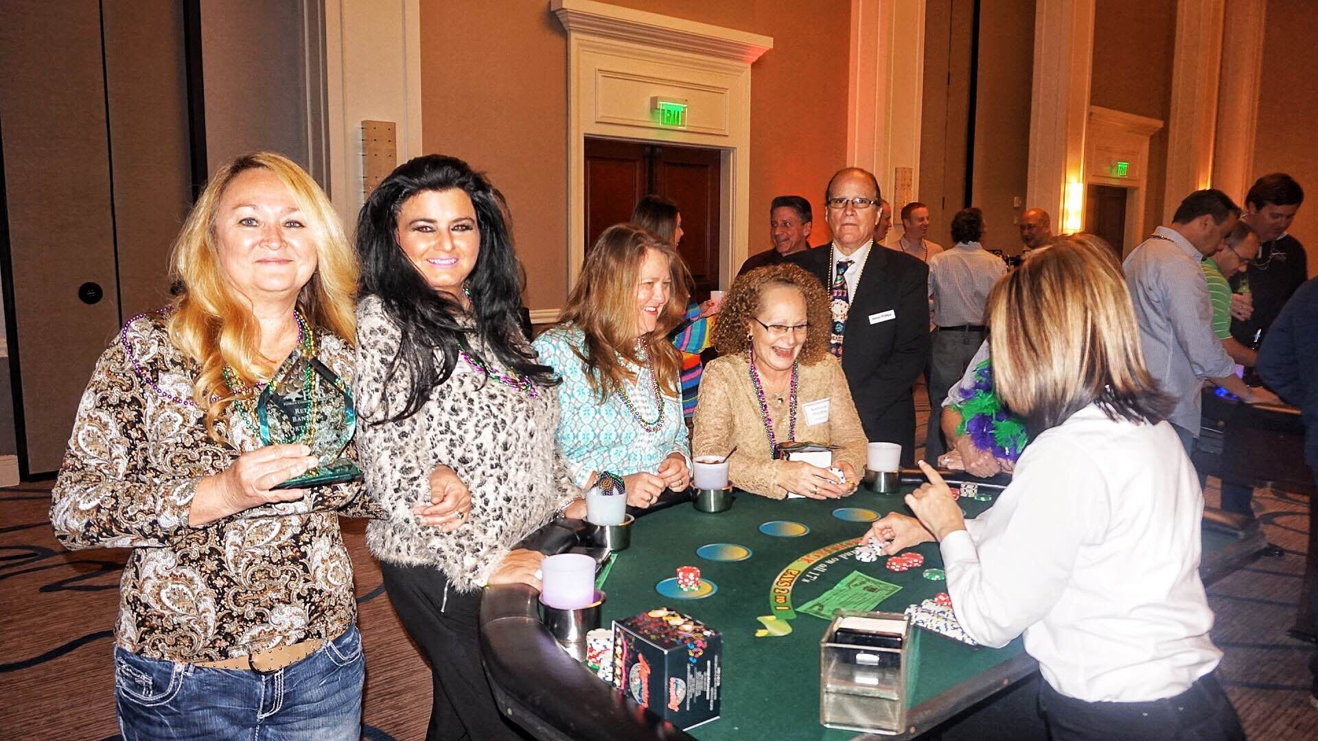 A group of people are sitting around a table playing poker.