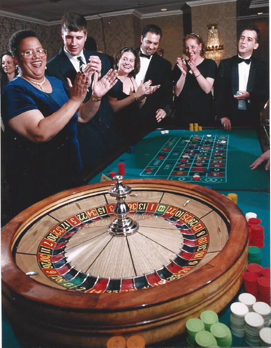 A group of people are playing roulette in a casino