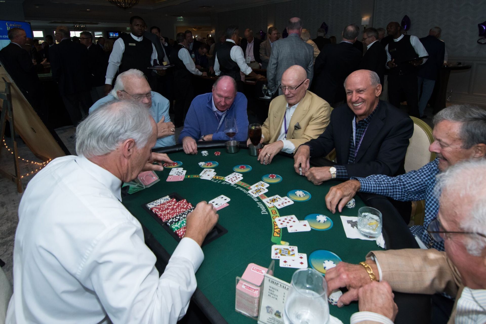 A group of men are playing a game of blackjack