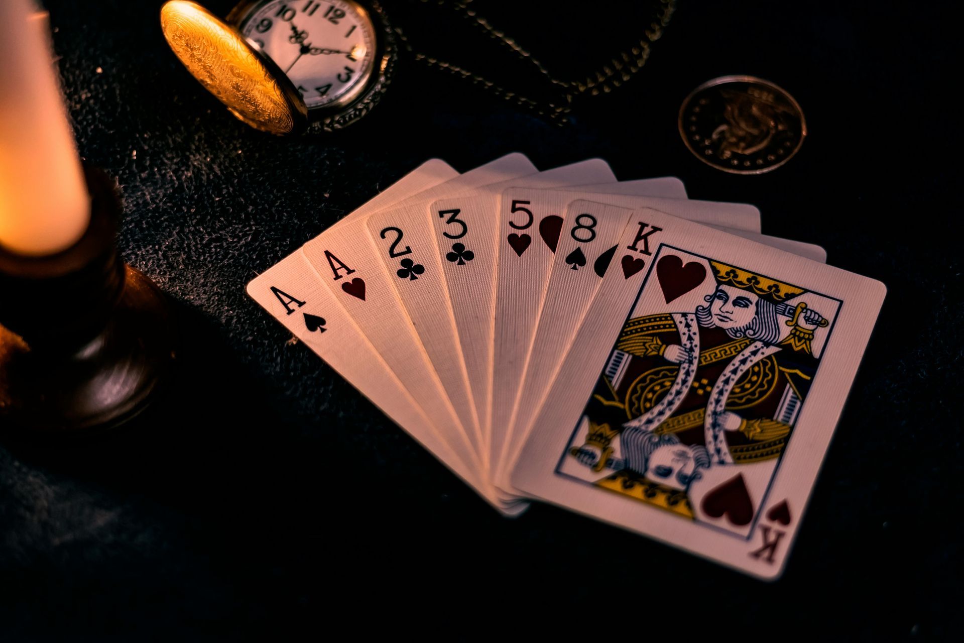 A bunch of playing cards are stacked on top of each other on a table.