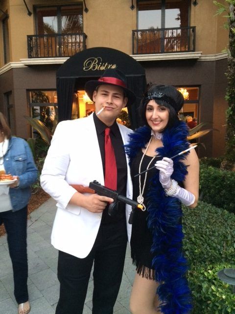 A man and a woman are posing in front of a building that says bistro