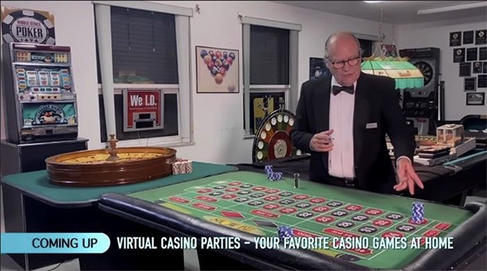 A man in a tuxedo is standing in front of a roulette table.