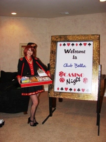 A woman is standing in front of a sign that says welcome to club bella