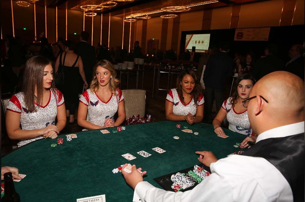 A group of people are playing poker at a table