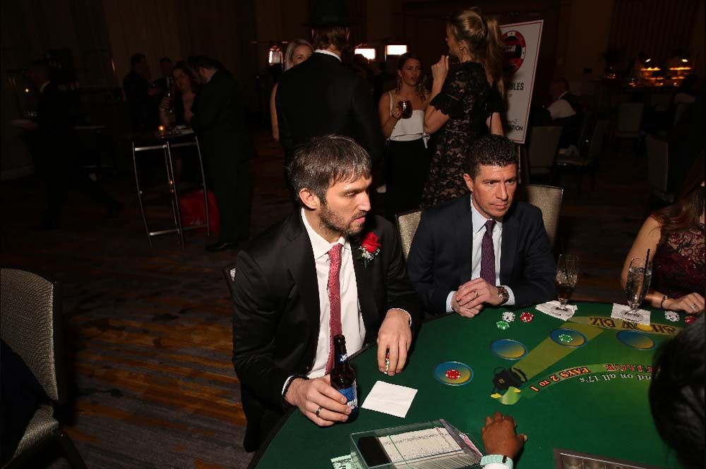 A group of men are sitting at a table playing poker.