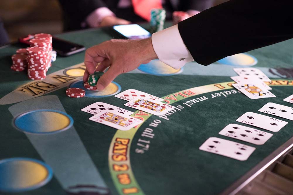 A man in a suit is playing a game of blackjack
