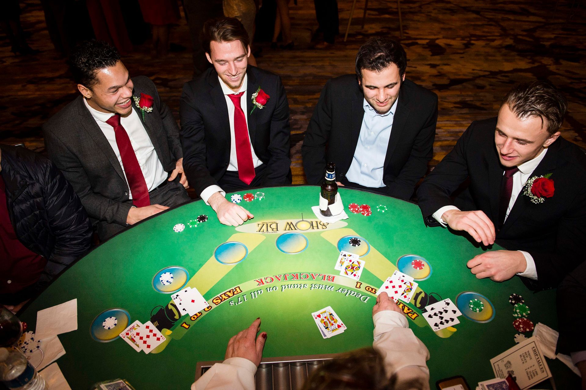 A group of men are playing a game of blackjack at a table.