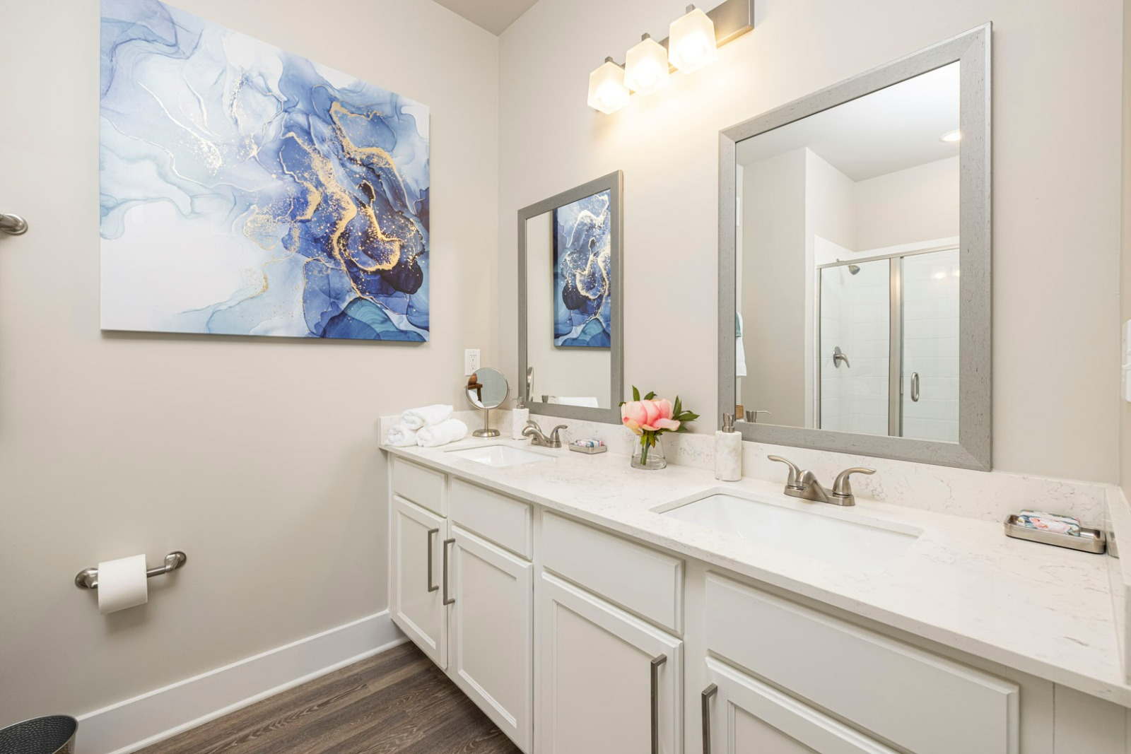 A bathroom with two sinks and two mirrors.
