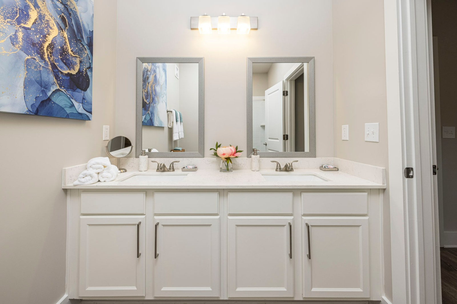 A bathroom with two sinks and two mirrors.