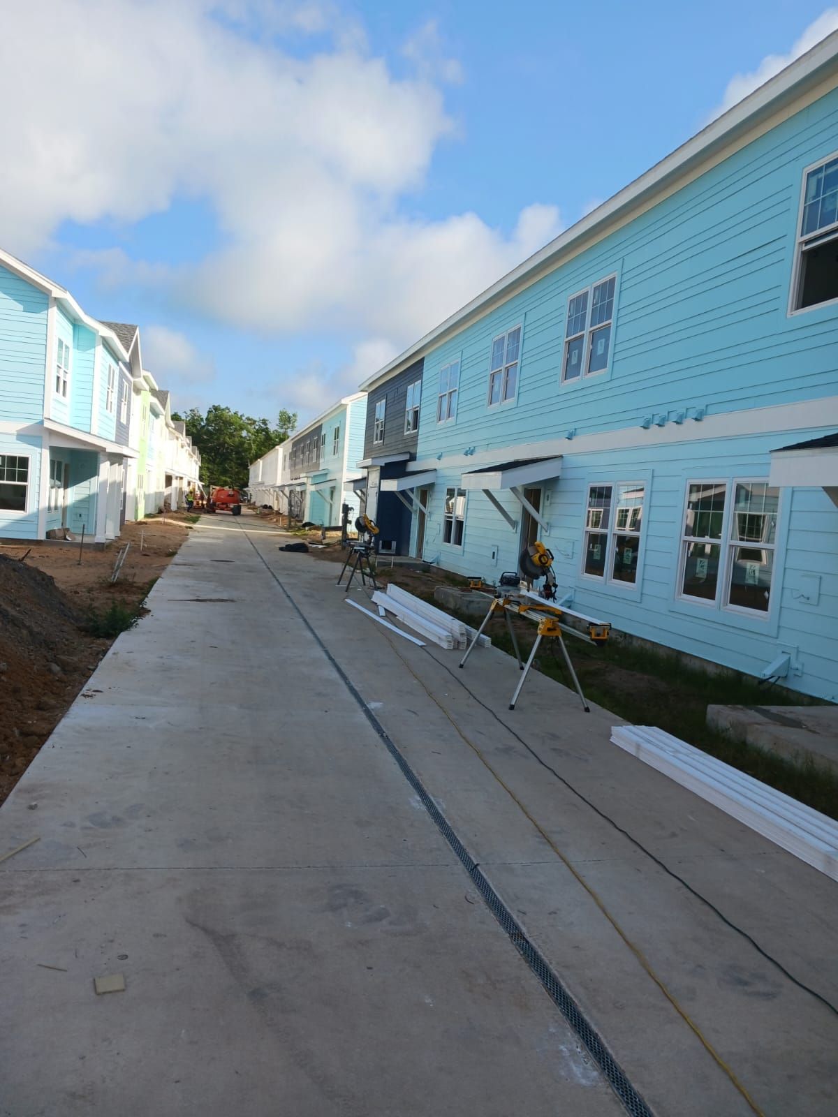A row of blue and white houses are being built