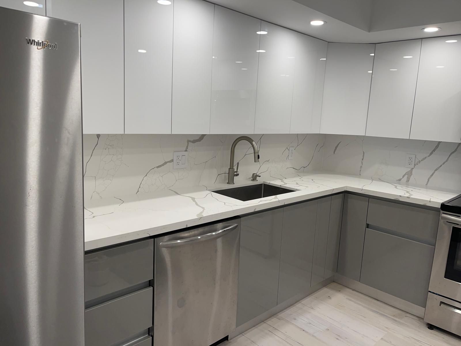 A kitchen with stainless steel appliances and white cabinets