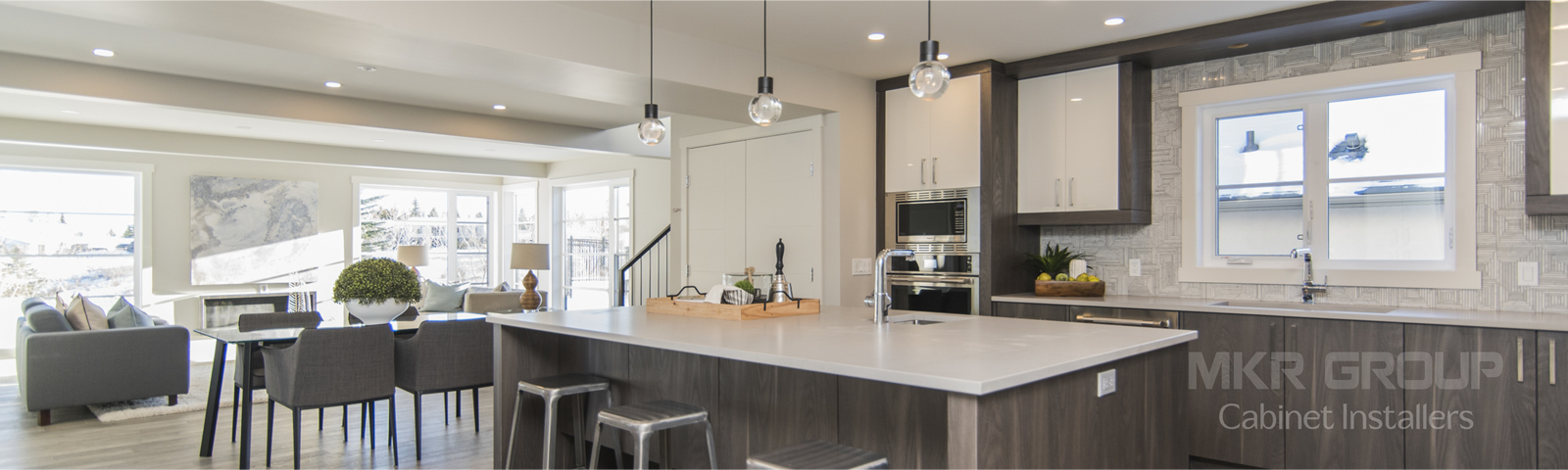 A kitchen with a large island and a dining room in the background.