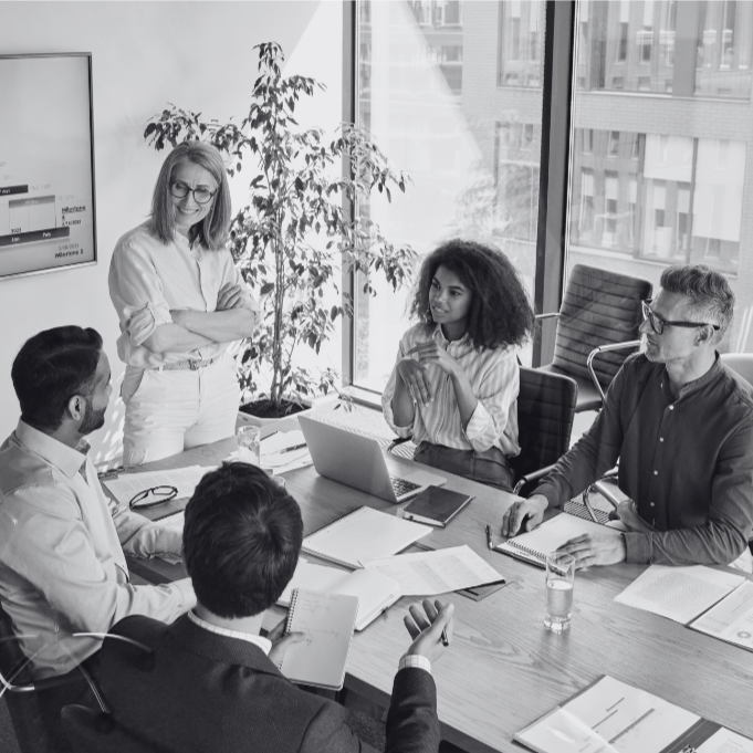 A group of business people sitting around a table to discuss ideas to improve their Small Business IT Support in St. Charles.