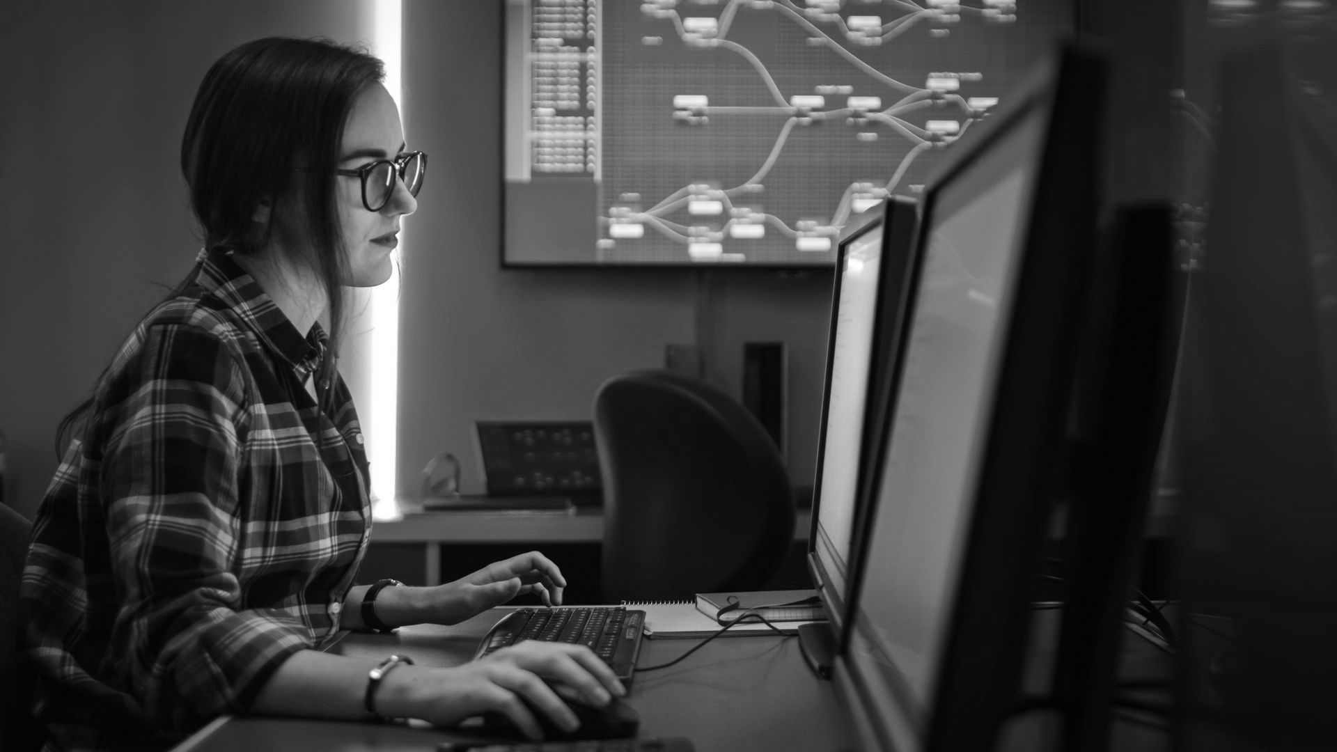 A young woman working in IT knows the importance of cyber security in the workplace