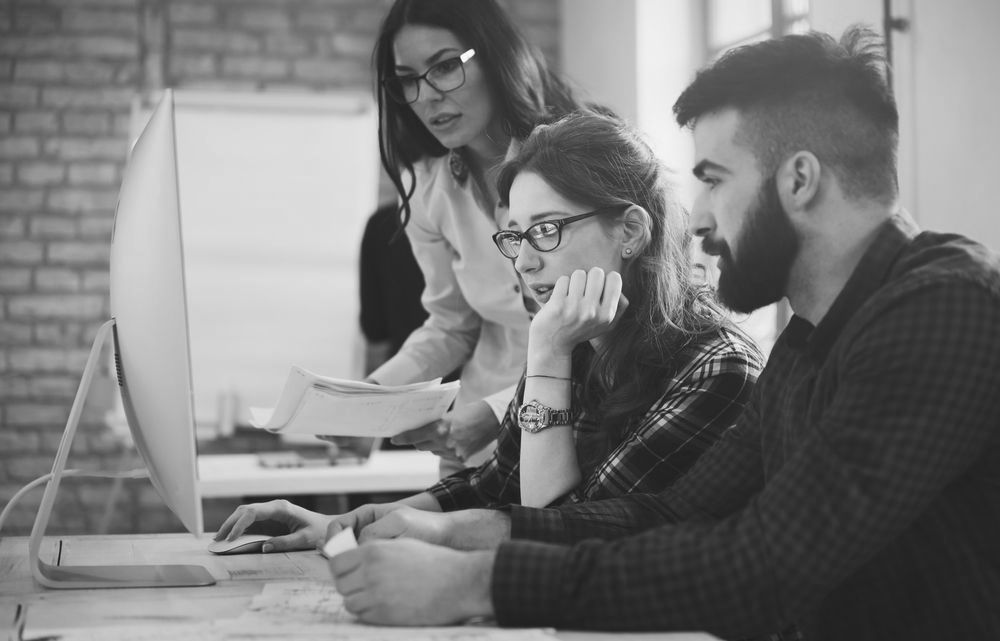 office coworkers working on managing their IT services for enhanced cybersecurity