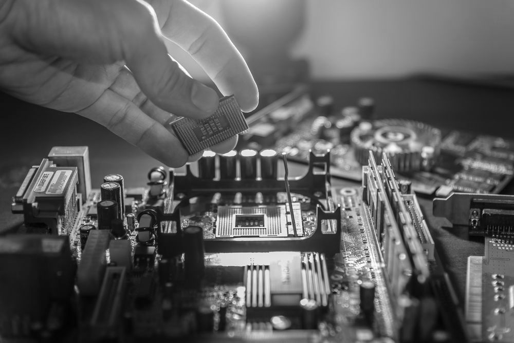 computer technician repairing computer hardware as part of hardware as a service practices