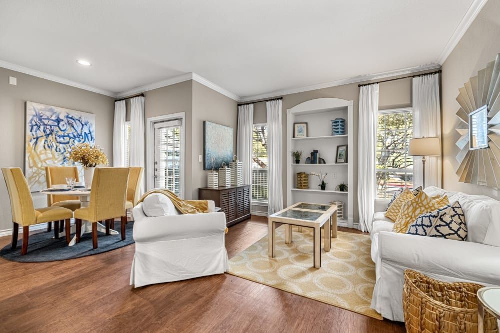 a living room with a couch, chairs, a table, and a bookshelf at Marquis at Deerfield in San Antonio, TX.