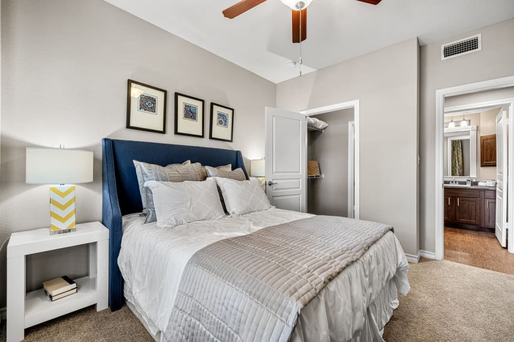 a bedroom with a large bed and a ceiling fan at Marquis at Deerfield in San Antonio, TX.