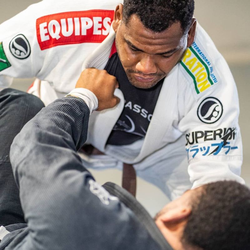 A man in a white gi with a red 