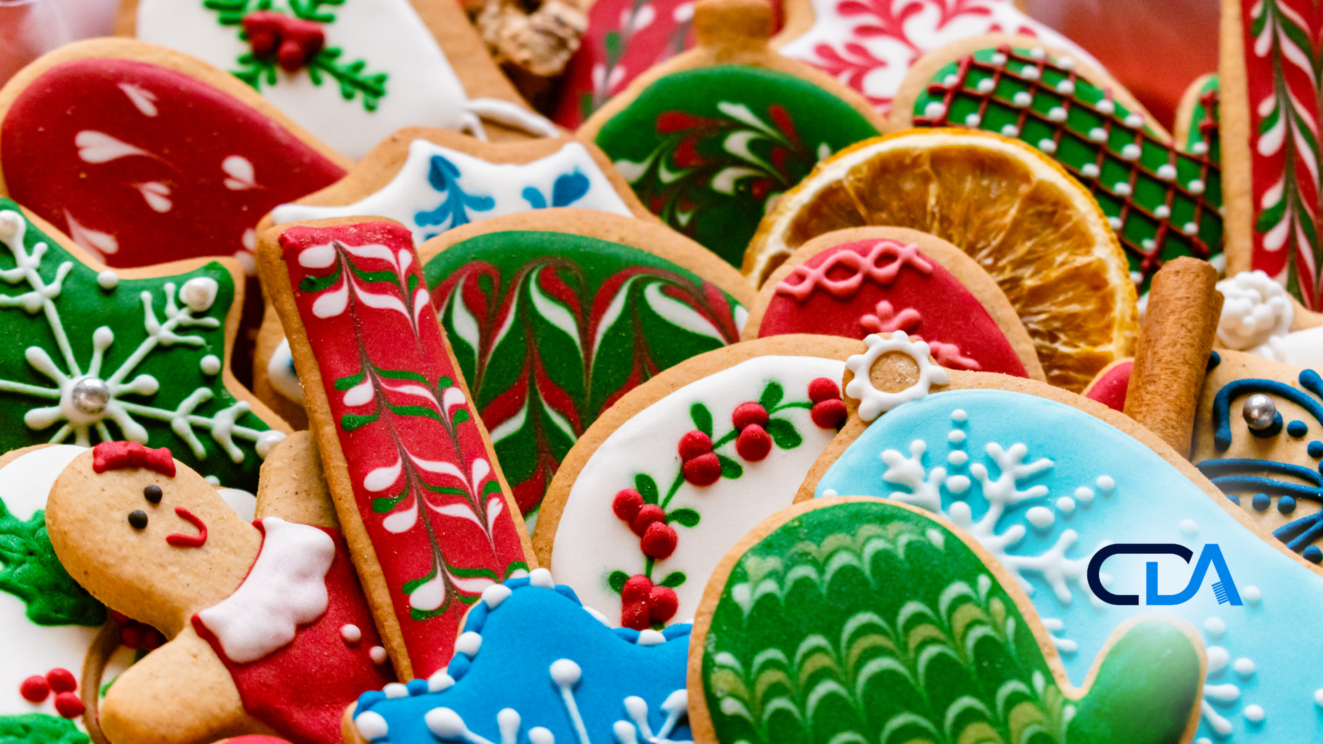 A pile of decorated christmas cookies on a table.