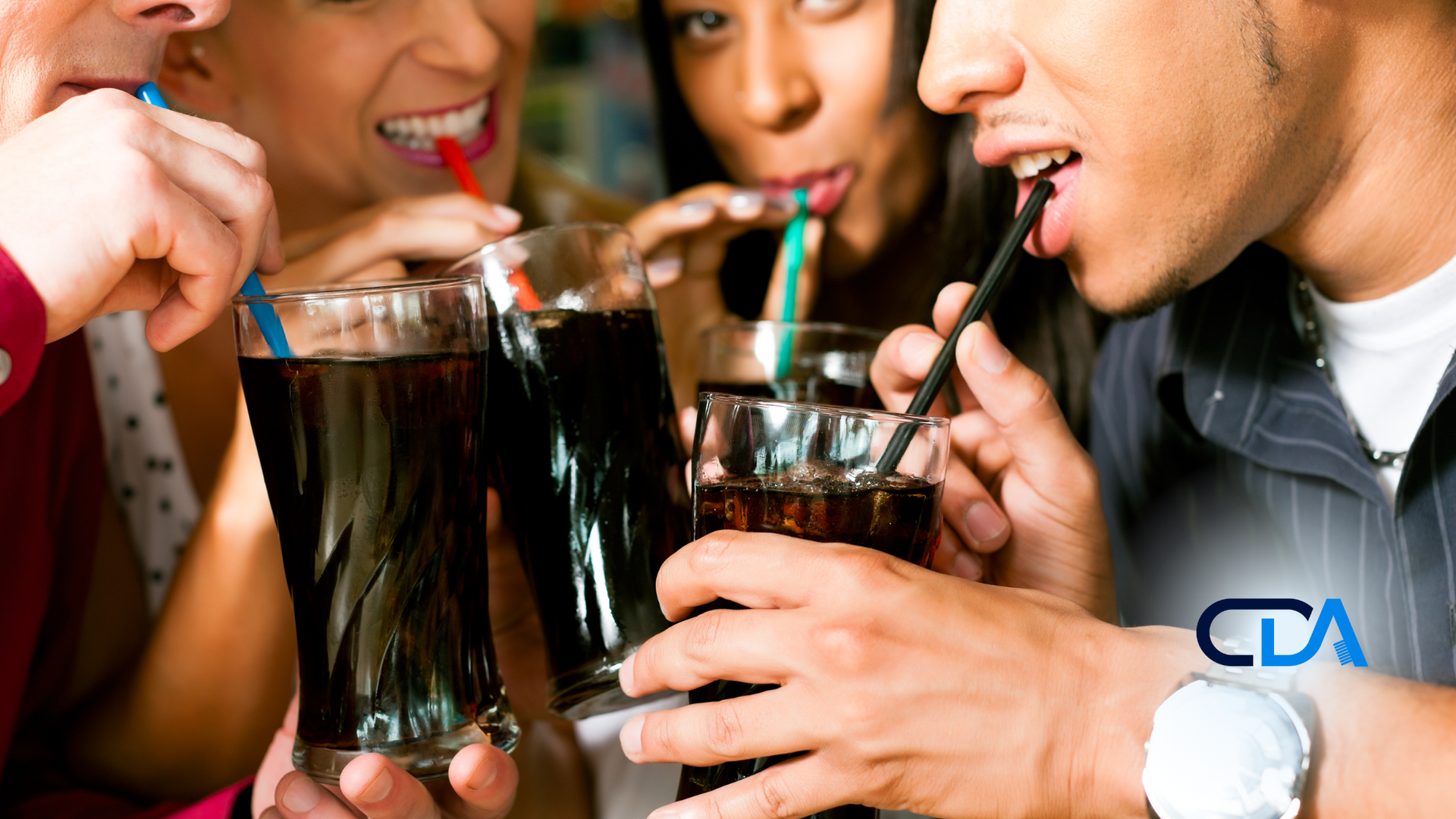 A group of people are drinking soda with straws.