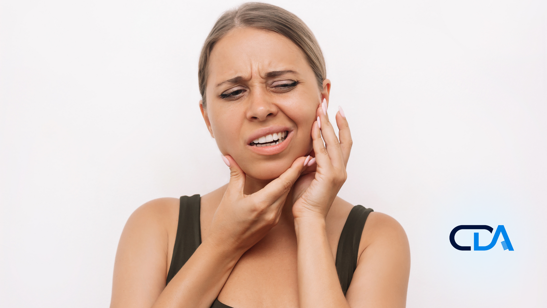 A woman is holding her face in pain because of a toothache.