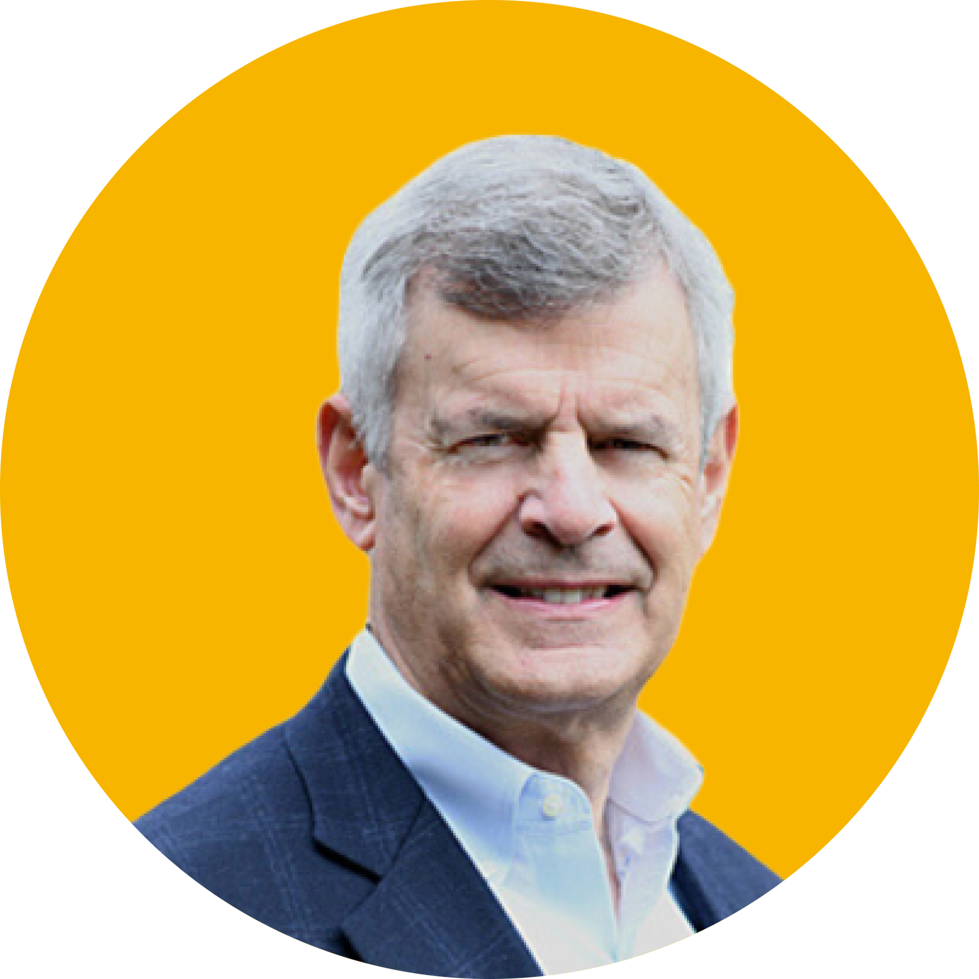 A smiling man in a dark blazer and collared shirt against a vibrant yellow circular background.