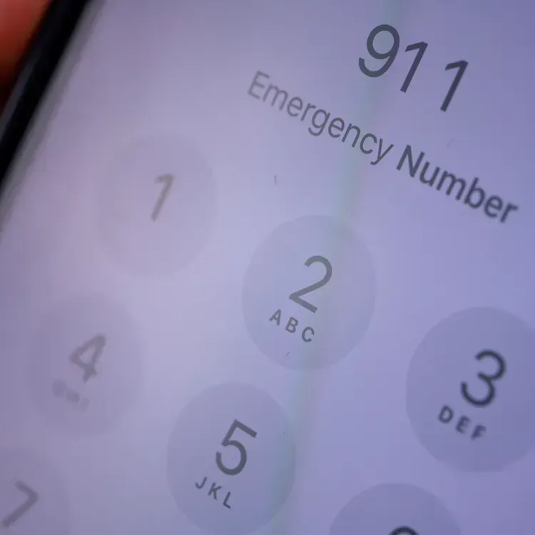 Close-up of a smartphone screen dialing 911, the emergency number.