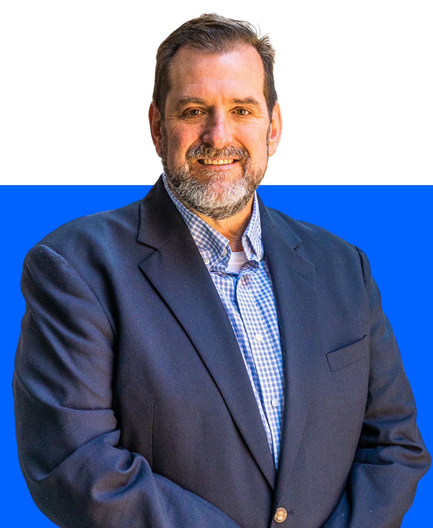 A smiling professional wearing a navy blazer and light patterned shirt, posing against a white and bright blue background.