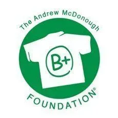 The Andrew McDonough B+ Foundation logo featuring a white t-shirt icon with a 