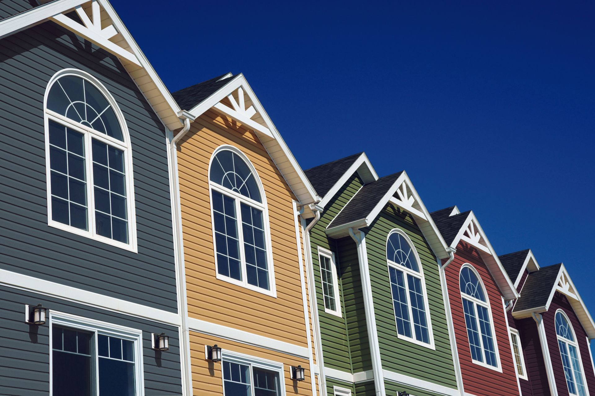 A row of houses with color siding