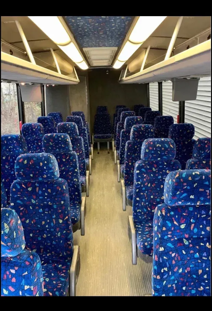 The inside of an empty bus with blue seats
