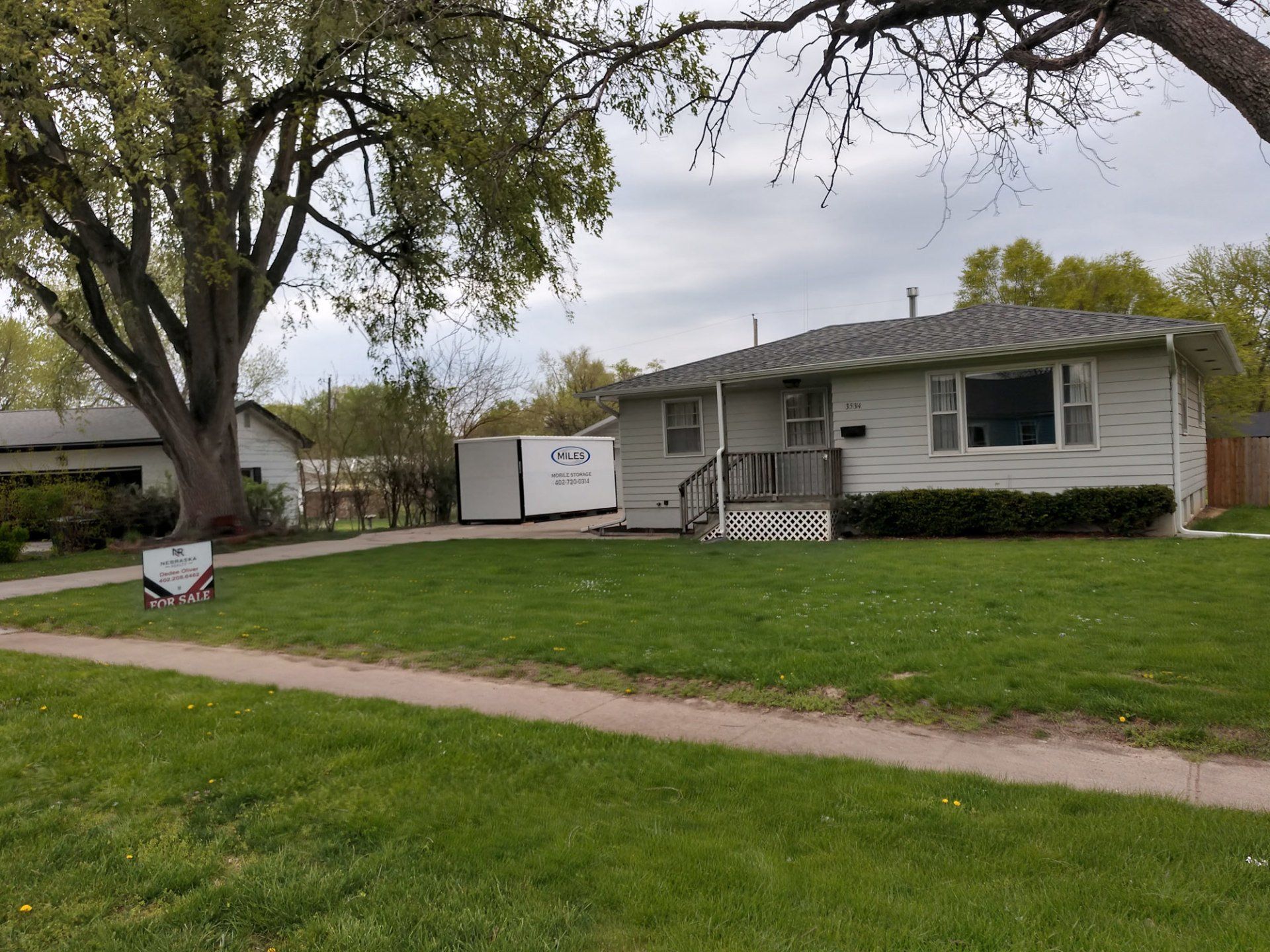 Portable Storage Bins — Miles Containers At The Side Of a House in Omaha, NE