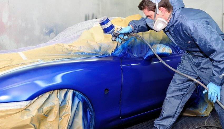 auto body painting technician at work on vehicle in Bryan and College Station, TX