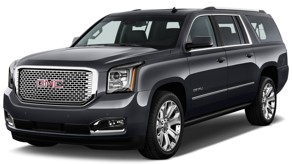 Dark gray GMC Yukon SUV, front view. Chrome grill and wheels, outdoors.