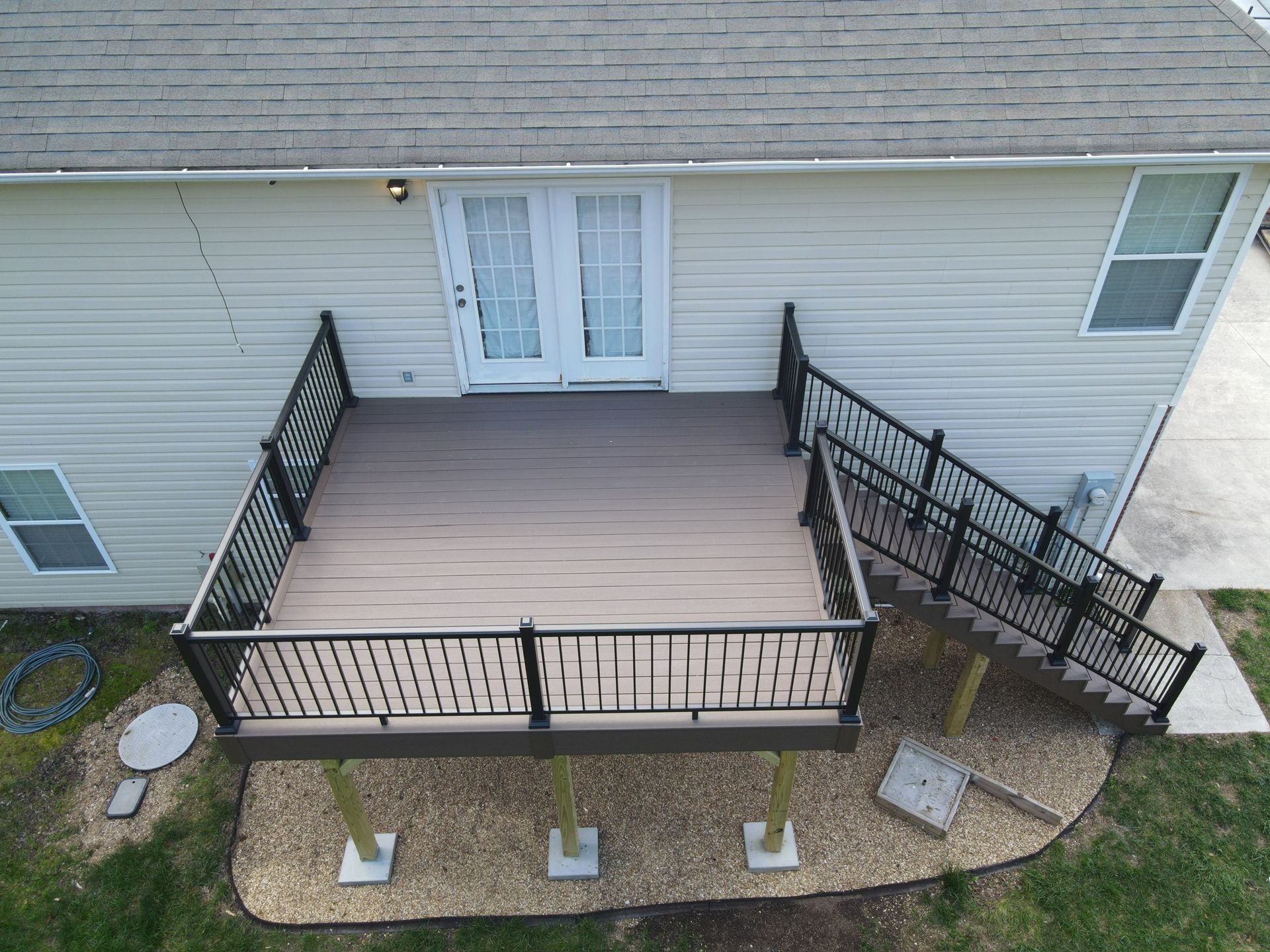 An aerial view of a house with a deck and stairs.