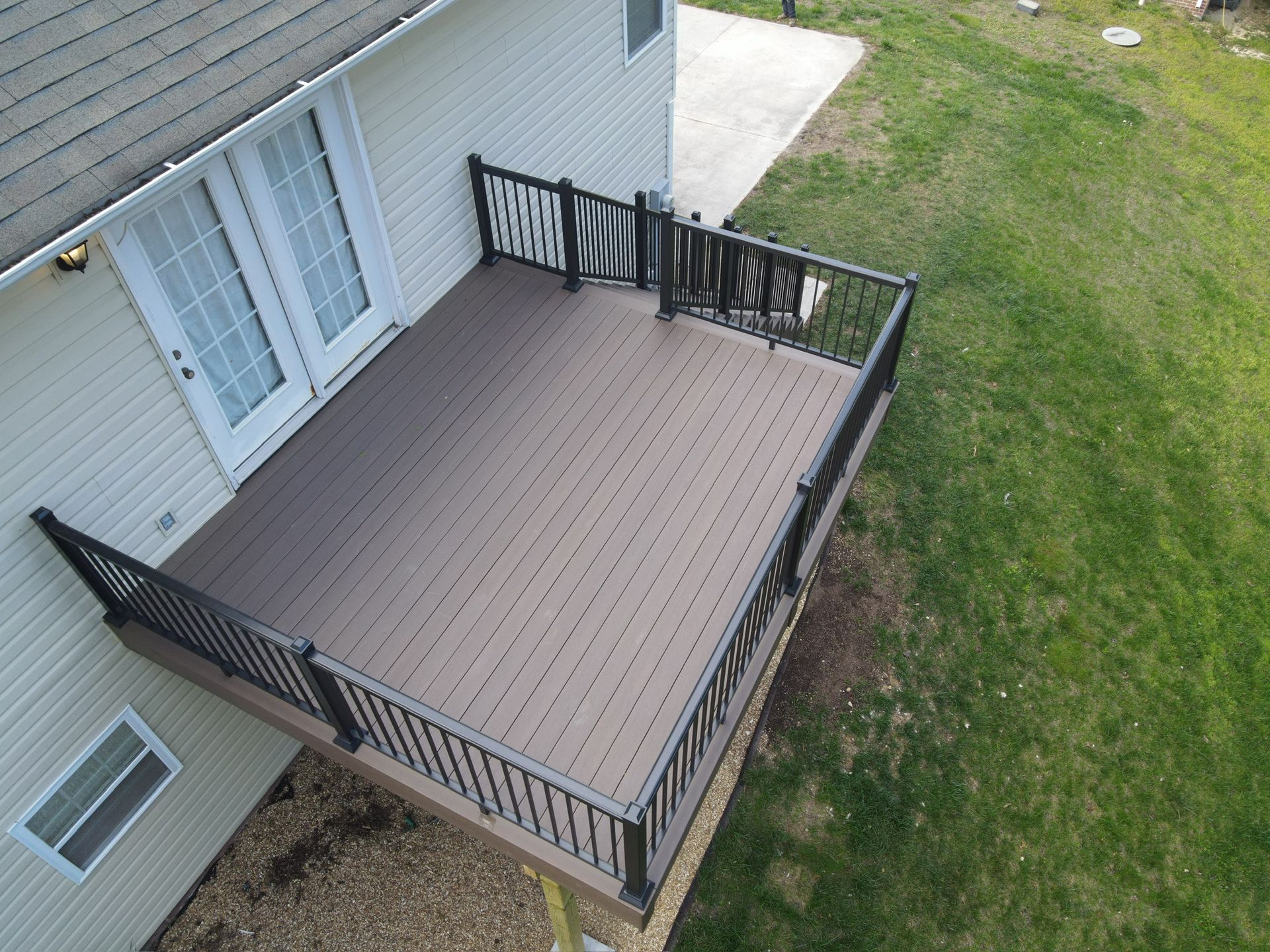 backyard deck with green trees