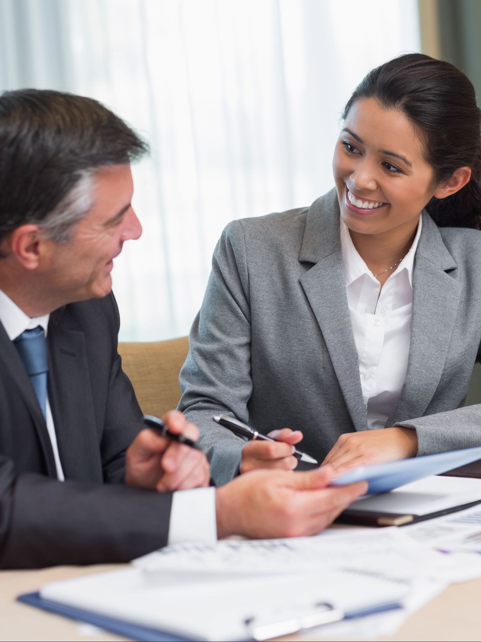 Two professionals reviewing legal documents during a consultation