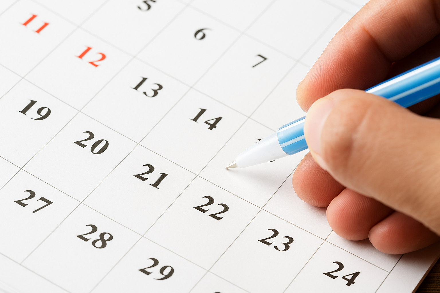 Close-up of a calendar being marked with a pen, symbolizing legal deadlines and eviction filing timelines for landlords