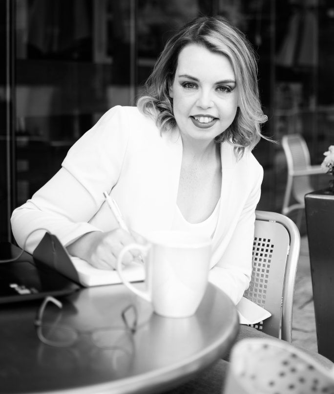 Siobhan Rocks, Ontario Licensed Paralegal and FLSP, sitting at a table taking notes while helping clients with family law, landlord–tenant, and small claims cases across Ontario