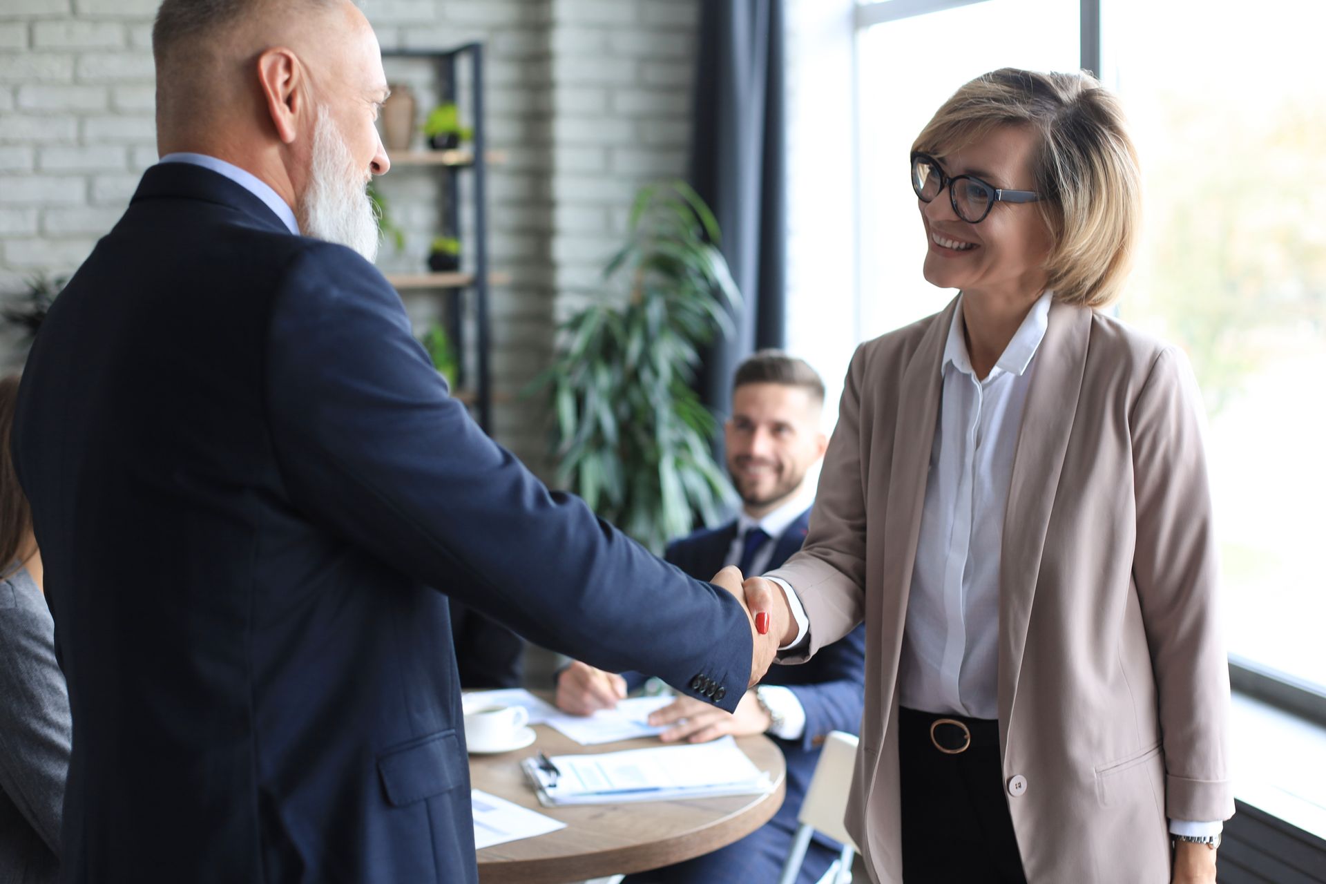 Professional landlord and legal representative shaking hands after resolving rental dispute in Ontario