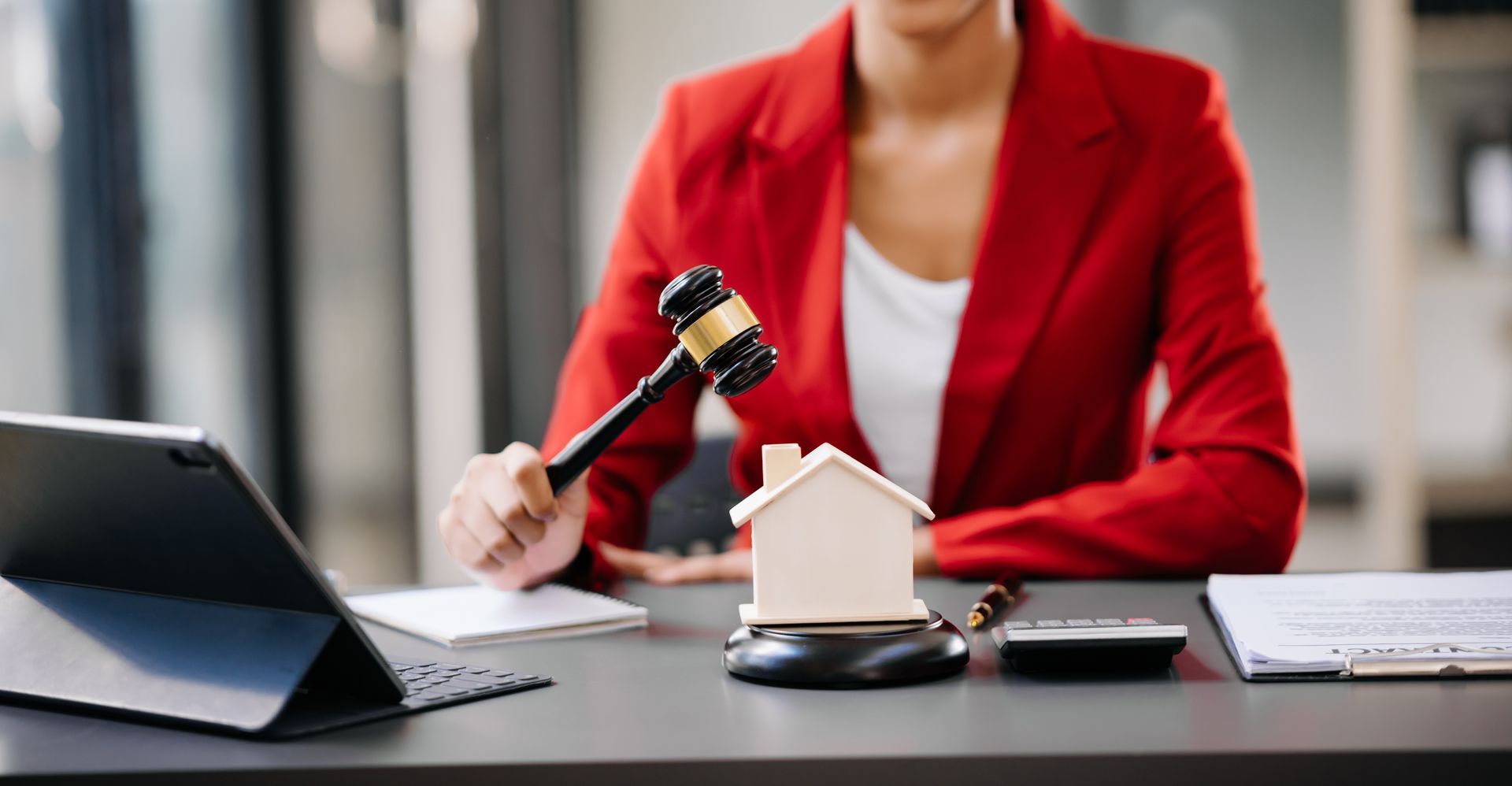 Paralegal or adjudicator with gavel and house model during a Landlord and Tenant Board hearing in ON