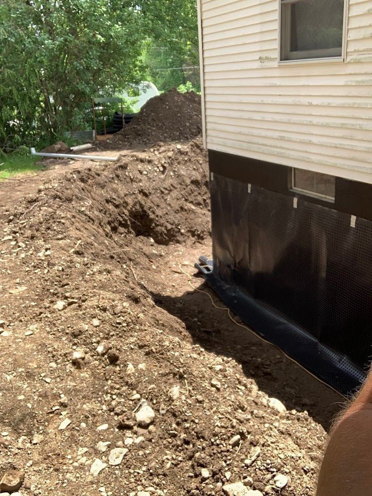 A large pile of dirt is sitting in front of a house.